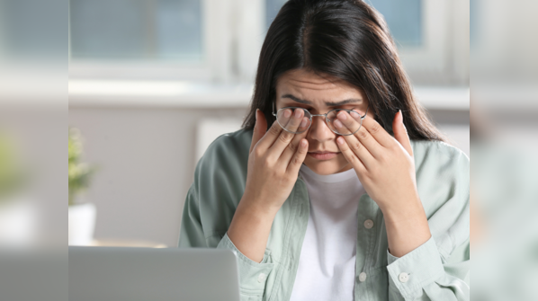 Woman rubbing her tired eyes.