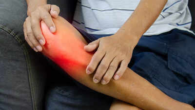 Person holding their painful knee