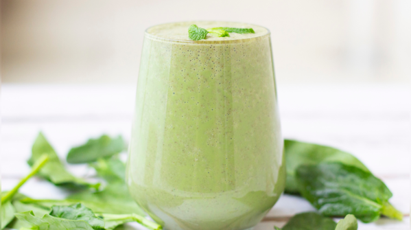 A glass of vibrant green smoothie